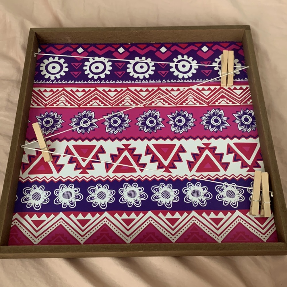 This is a piece of wall decor with bright colors and unique details!